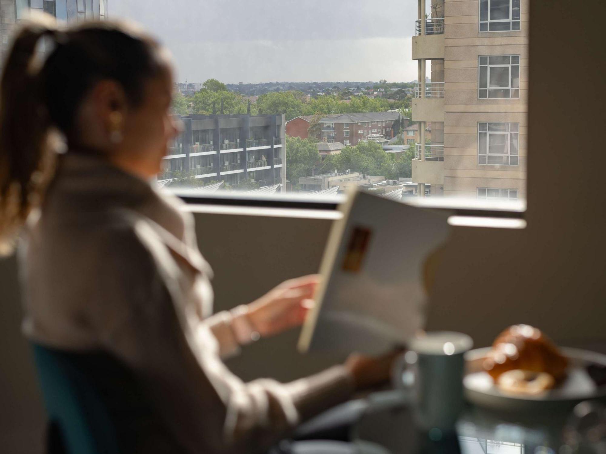 The Olsen Melbourne Art Series Экстерьер фото A woman using a tablet